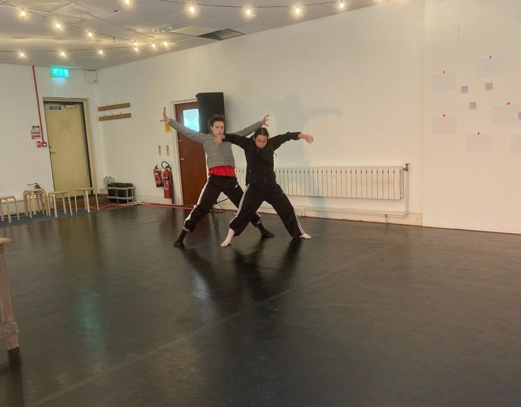 Two dancers with arms and legs outstretched in the MAYKING Space as part of the C'mon in the water's lovely residency