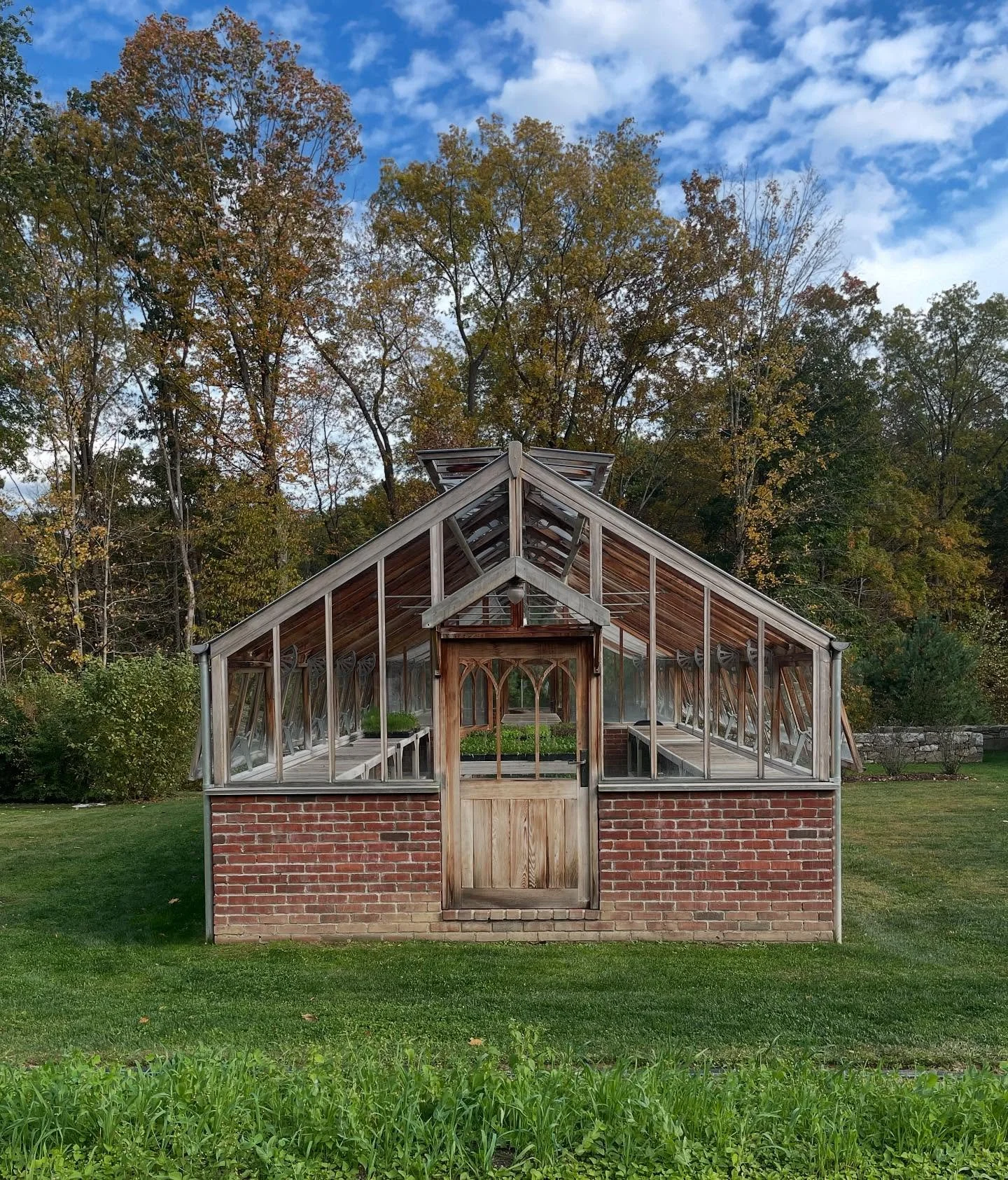The greenhouse is empty now, framed by the colors of fall and the quiet that comes at the end of a growing season. But this simple space is a reminder, even in its stillness, that our work continues.

While the harvest may be over, our calendar is fu