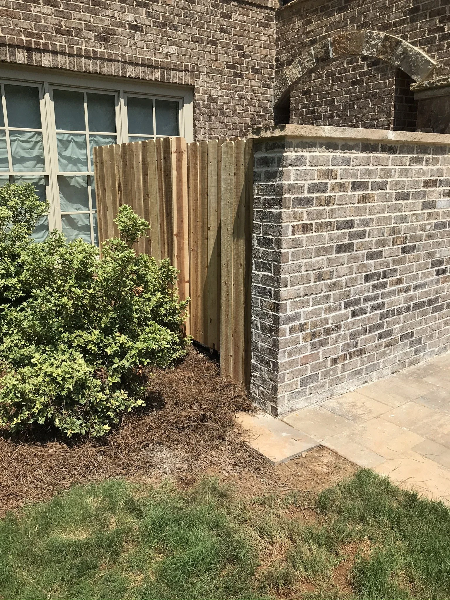 Brick privacy wall and gate to conceal pool equipment.  
