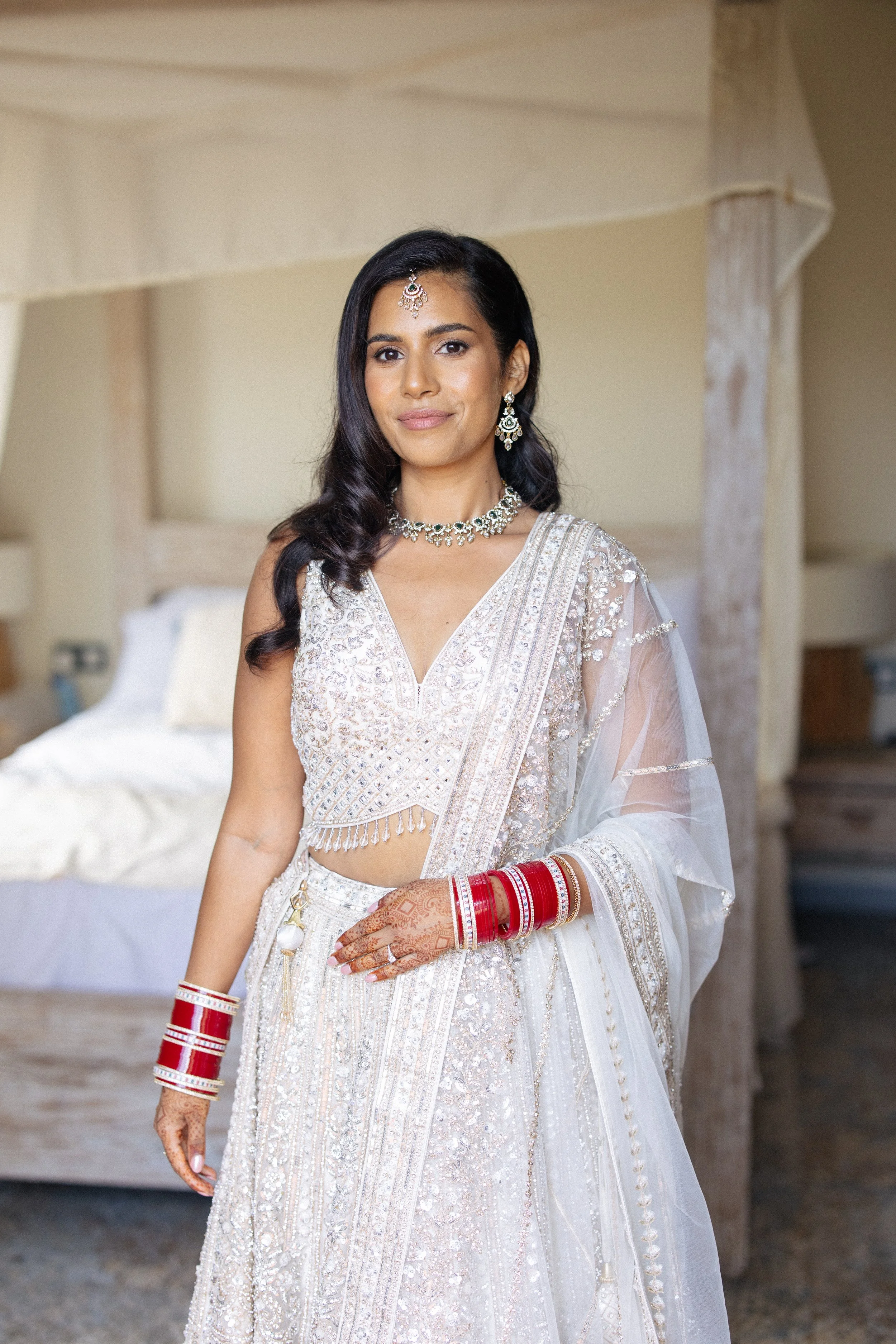 A bride poses in Indian wedding attire before her wedding ceremony at Mas Del Sord