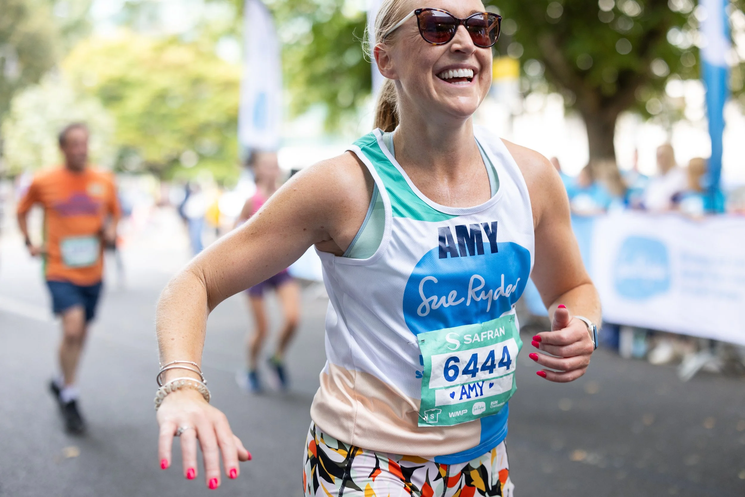 A woman running the Cheltenham Half Marathon for Sue Ryder.