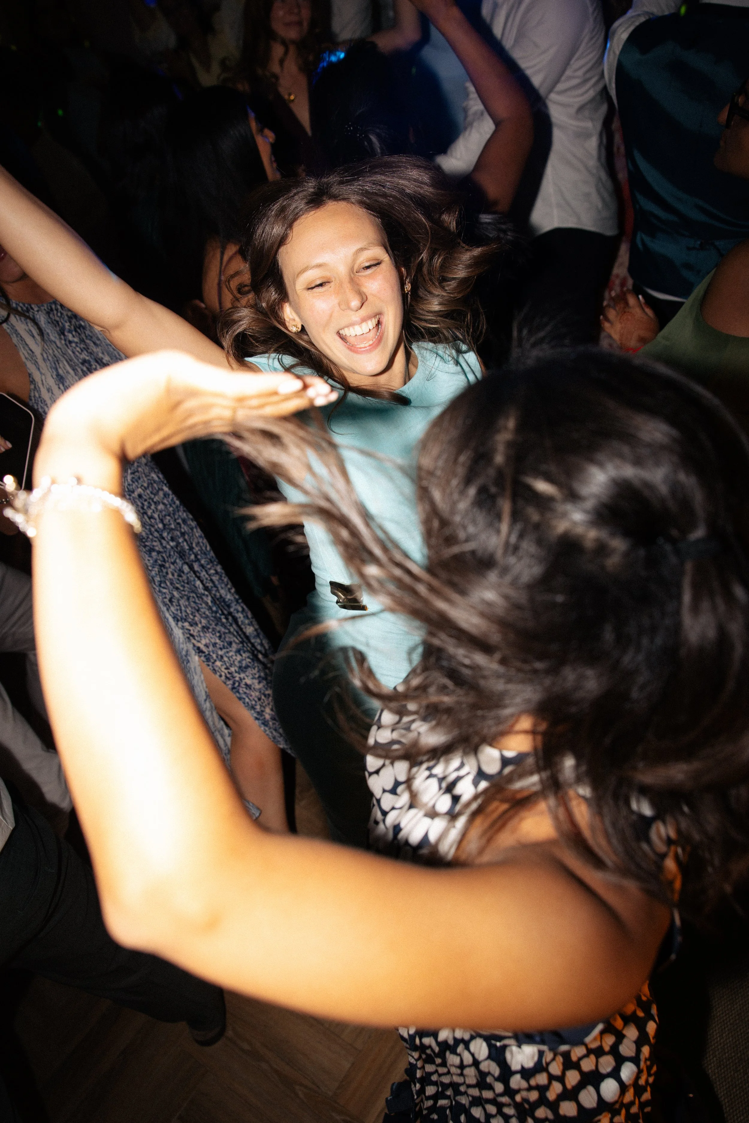 Guests dance enthusiastically on the dance floor at a wedding at Crockwell Farm