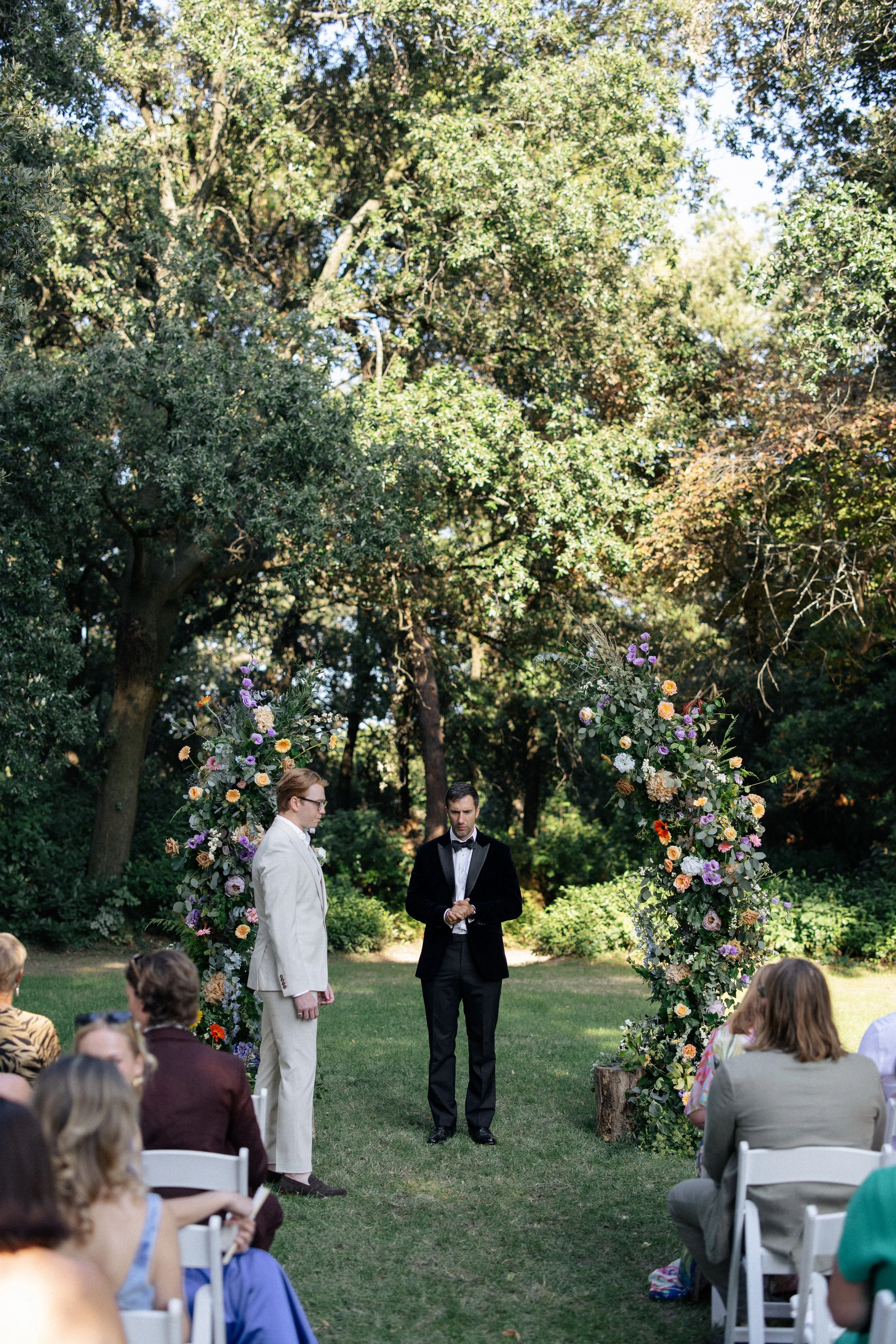 A groom awaits his bride at the front of the wedding ceremony at Villa Giulia in Fano, Italy