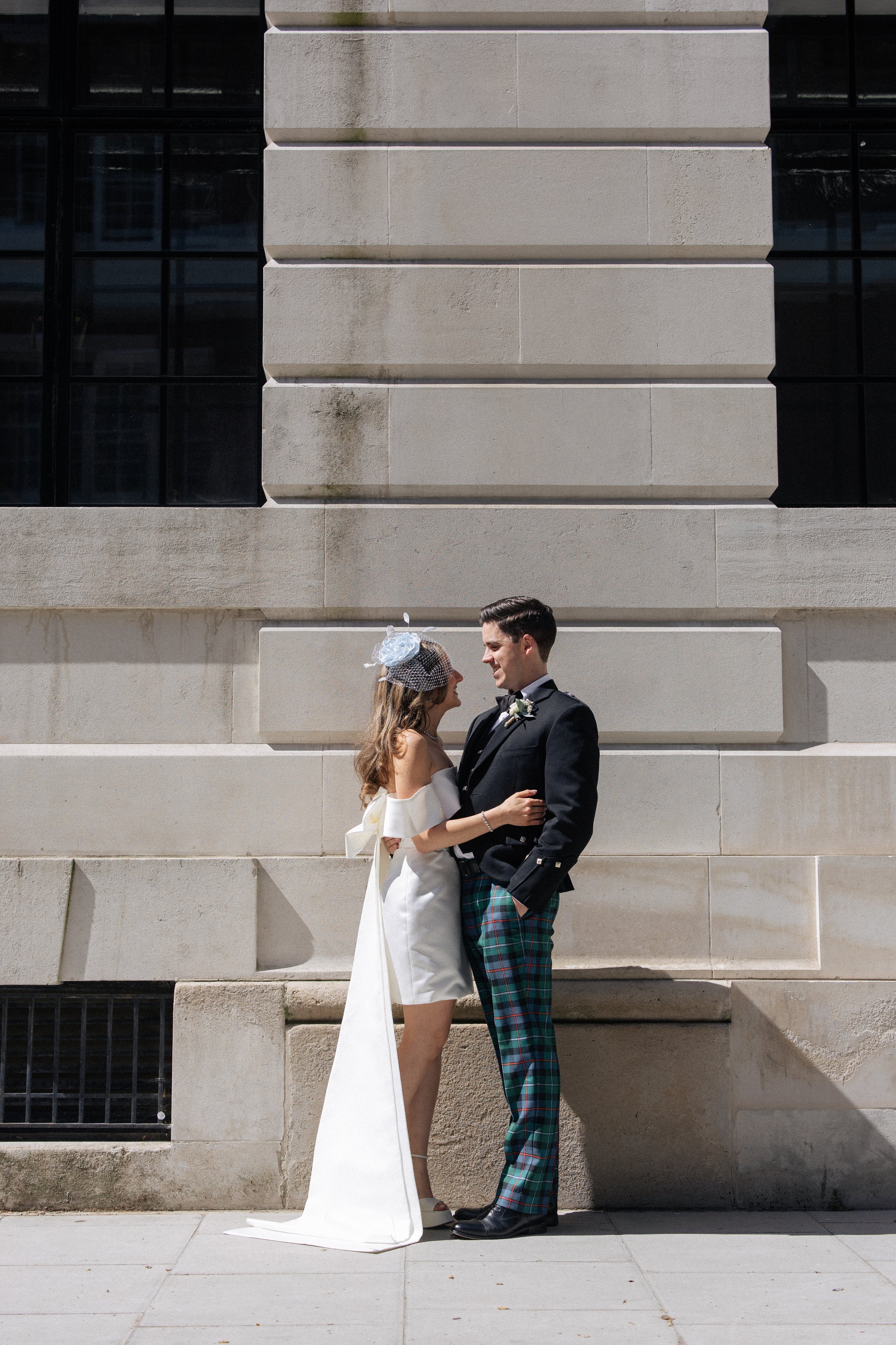 A couple cuddle and laugh after their wedding ceremony at Camden Town Hall