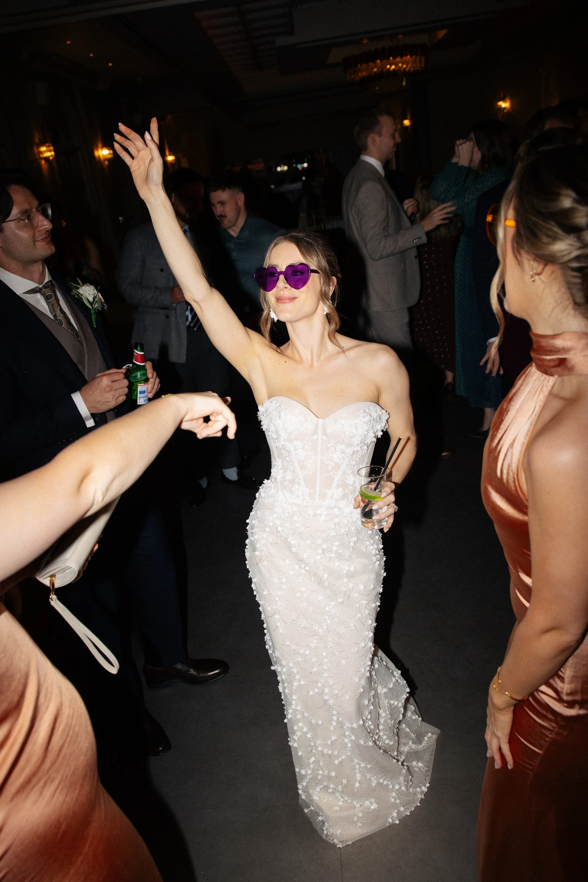 A bride is wearing sunglasses on the dance floor at her wedding at the Orangery Maidstone