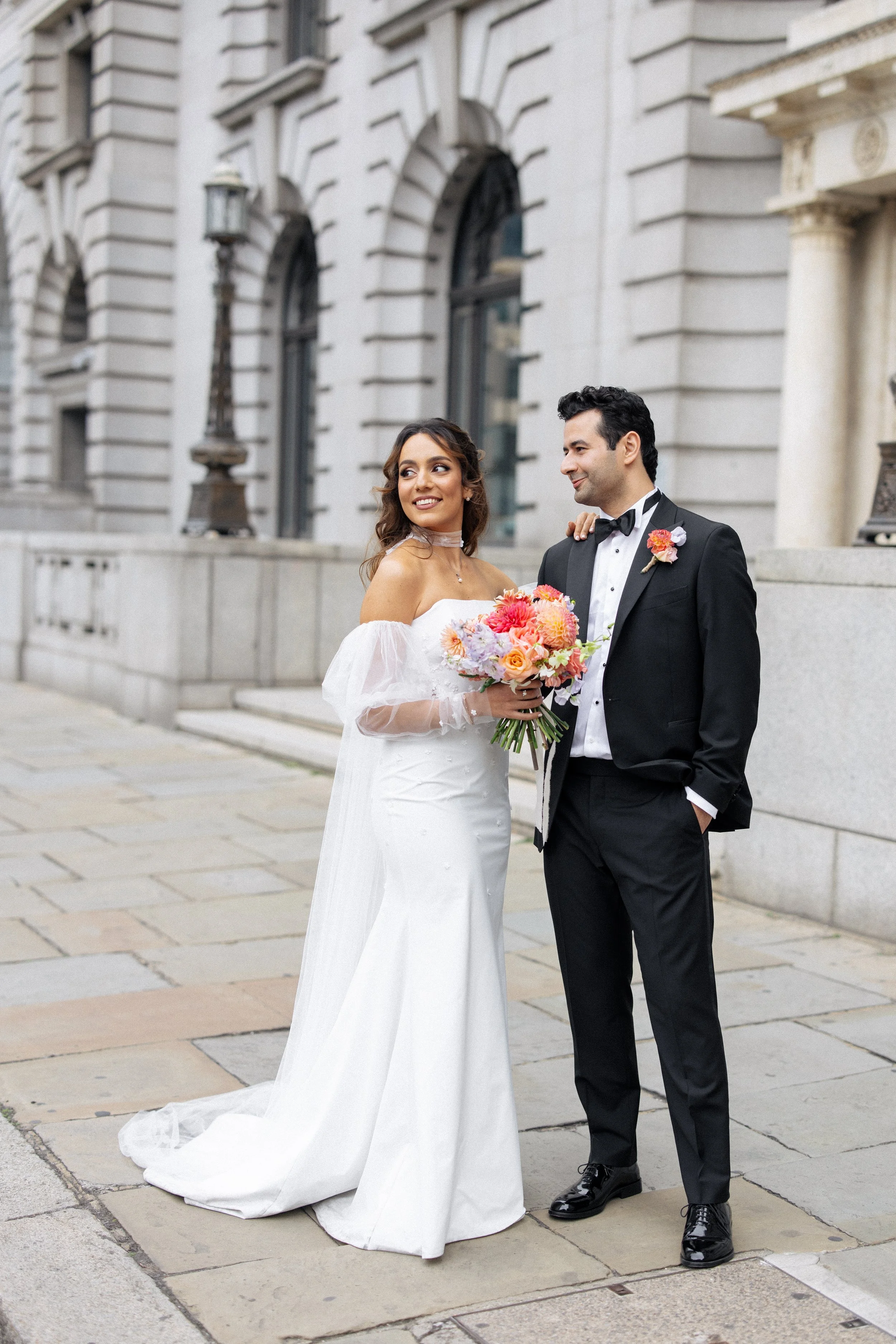 A bride and groom pose for portraits in the streets of London during their wedding at Singer Tavern