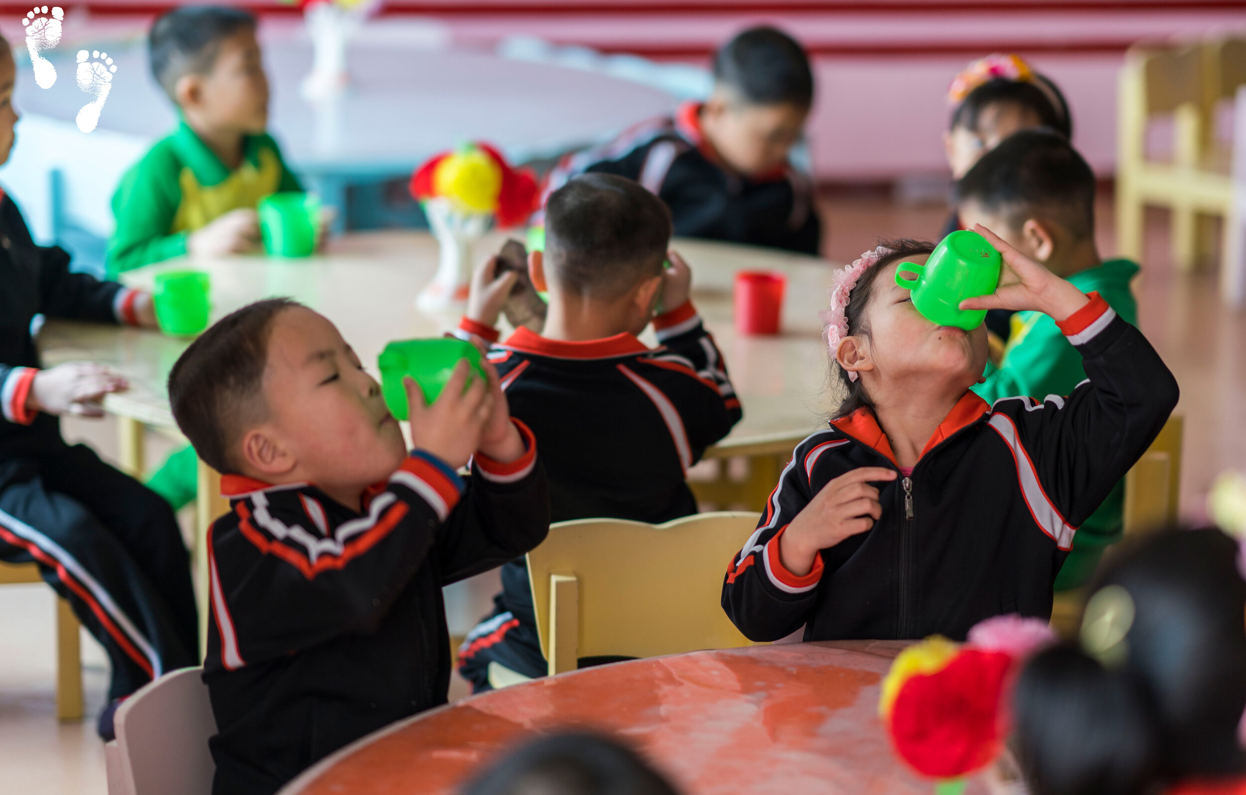 Children at the Nampo Kindergarten Orphanage enjoying fresh soymilk.