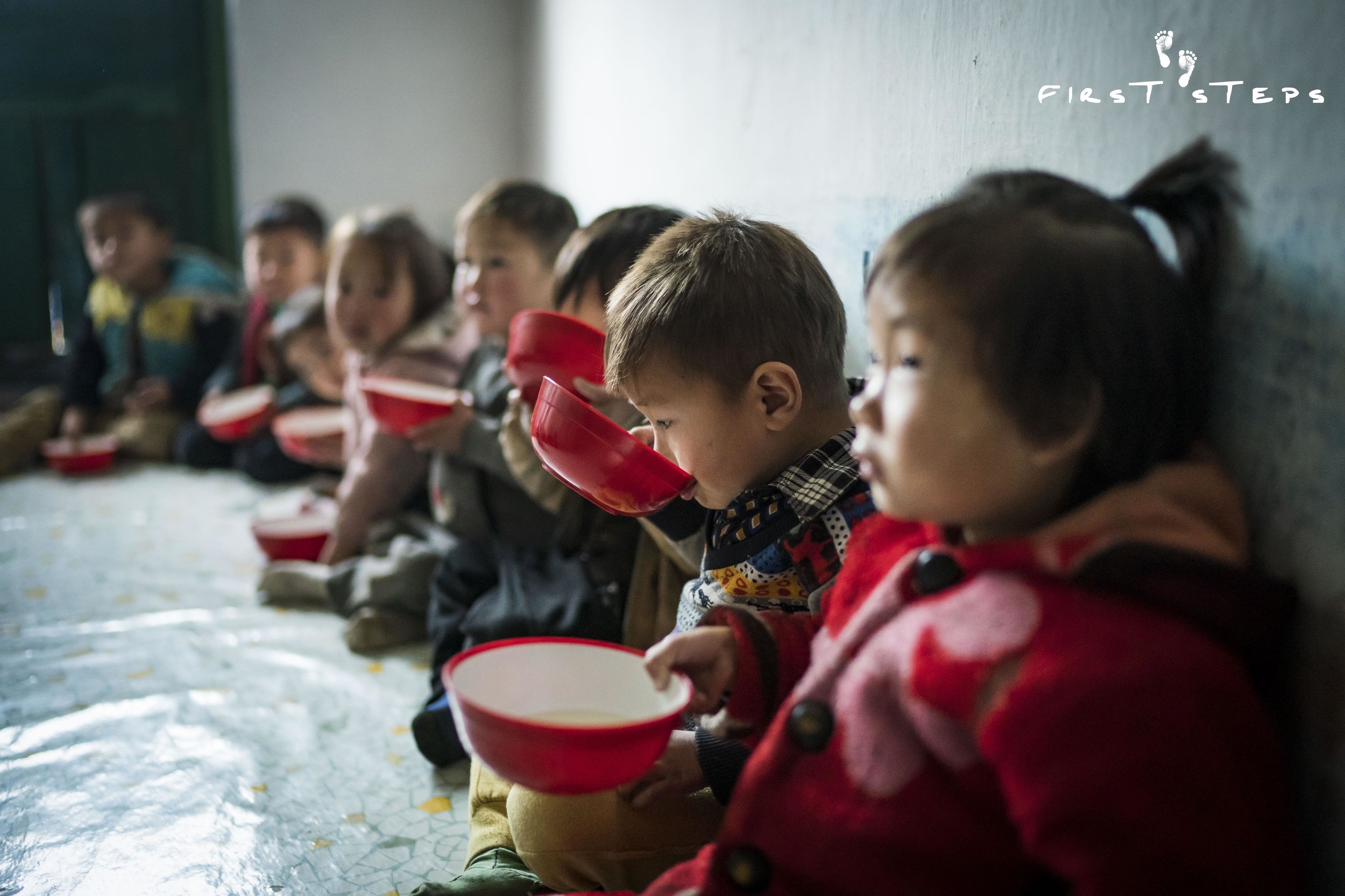 The children at the Rosang-Ri #1 Daycare slurp up their soymilk quietly and contentedly.