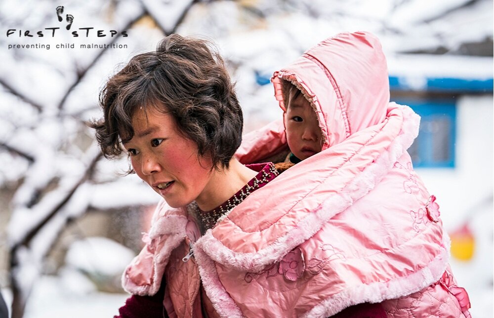 A mother and her son arriving to the Yangji Daycare in Wonsan, Kangwon Province