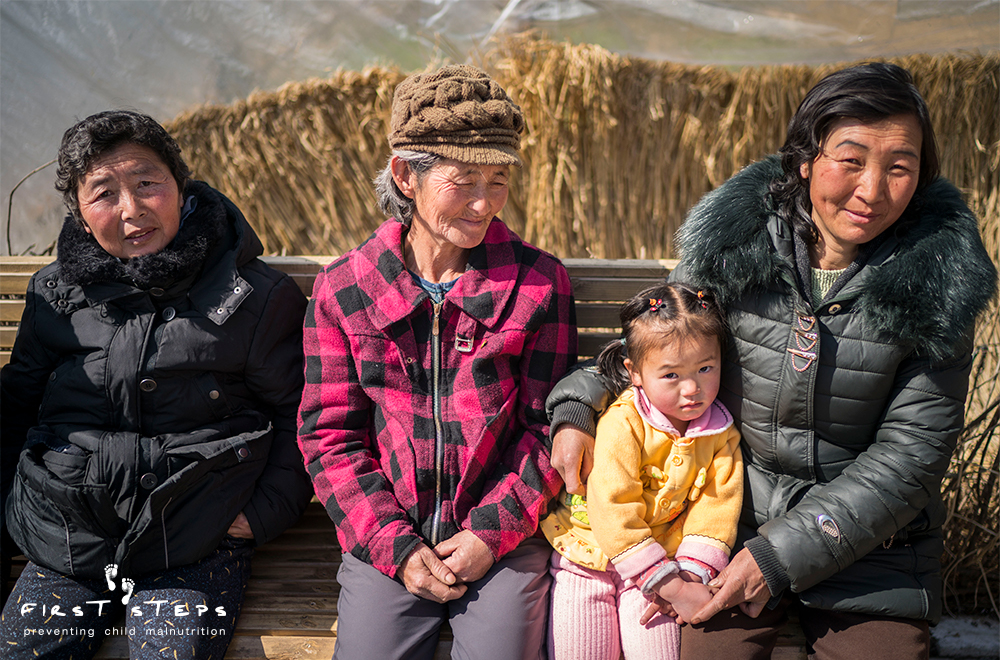 Patients sit outside at the Shinmi Clinic in Hyongjesan.