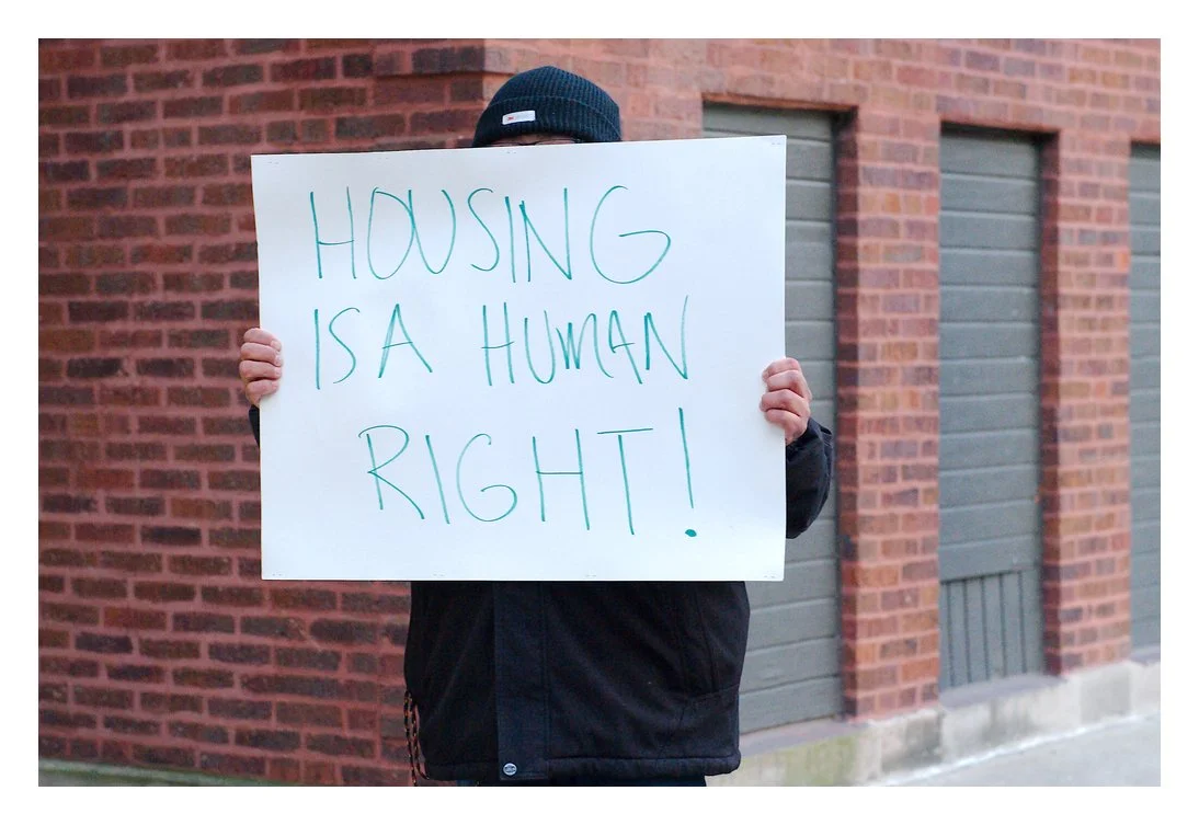 Sign reads, "Housing is a Human Right!"
