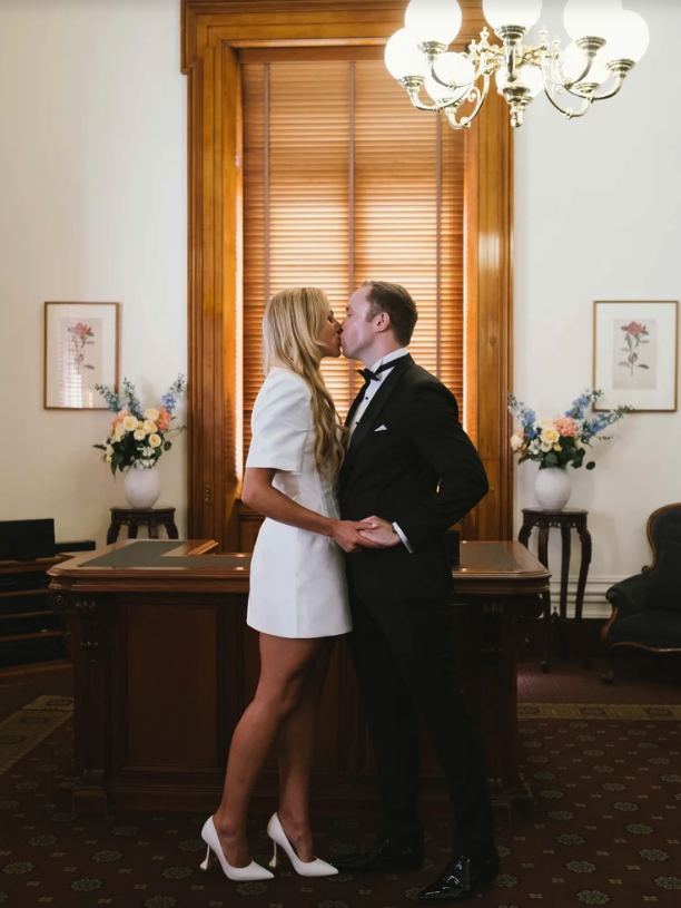 A couple having their first kiss after their registry wedding at old treasury building