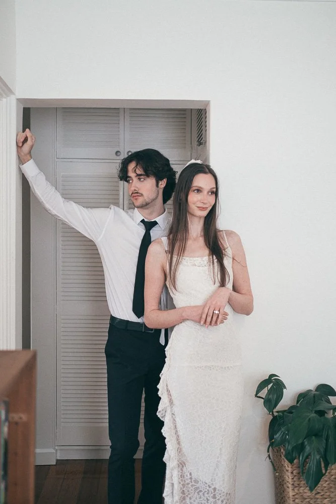 , BRIDE AND GROOM CASUALLY POSING INSIDE AN APARTMENT
