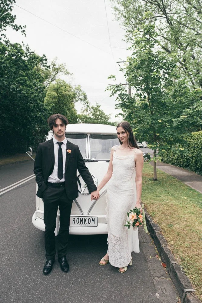 MELBOURNE  EDITORIAL WEDDING PHOTOGRAPHY, BRIDE AND GROOM POSING NEXT TO A OLD SCHOOL VW KOMBI VAN, HOLDING HANDS