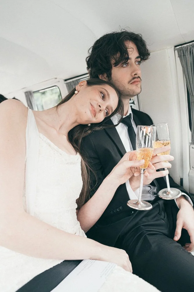 MELBOURNE  EDITORIAL WEDDING PHOTOGRAPHY, BRIDE AND GROOM POSING NEXT TO A OLD SCHOOL VW KOMBI VAN, INSIDE THE VAN HAVING A CHAMPAGNE IN CLASSIC FLUTES