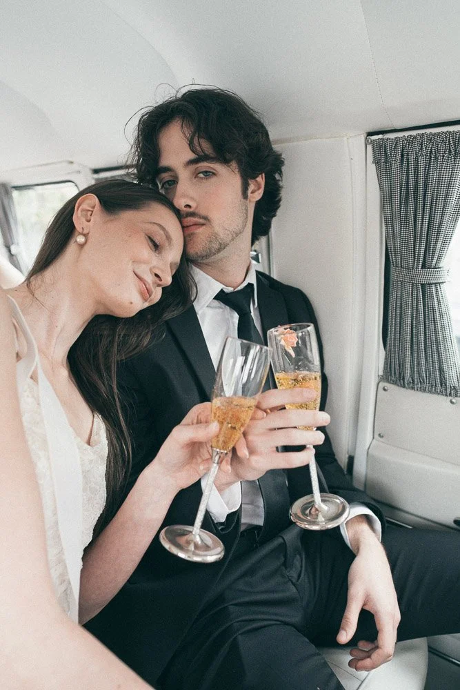 MELBOURNE  EDITORIAL WEDDING PHOTOGRAPHY, BRIDE AND GROOM POSING NEXT TO A OLD SCHOOL VW KOMBI VAN, INSIDE THE VAN HAVING A CHAMPAGNE IN CLASSIC FLUTES, KISSING