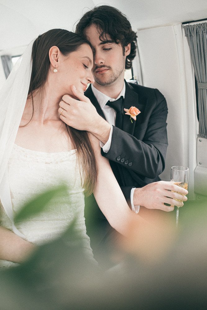 MELBOURNE  EDITORIAL WEDDING PHOTOGRAPHY, BRIDE AND GROOM POSING NEXT TO A OLD SCHOOL VW KOMBI VAN, INSIDE THE VAN HAVING A CHAMPAGNE IN CLASSIC FLUTES