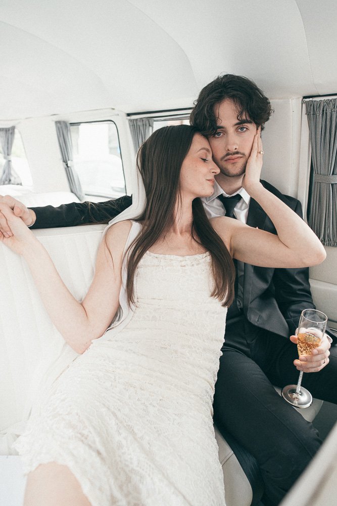MELBOURNE  EDITORIAL WEDDING PHOTOGRAPHY, BRIDE AND GROOM POSING NEXT TO A OLD SCHOOL VW KOMBI VAN, INSIDE THE VAN HAVING A CHAMPAGNE IN CLASSIC FLUTES