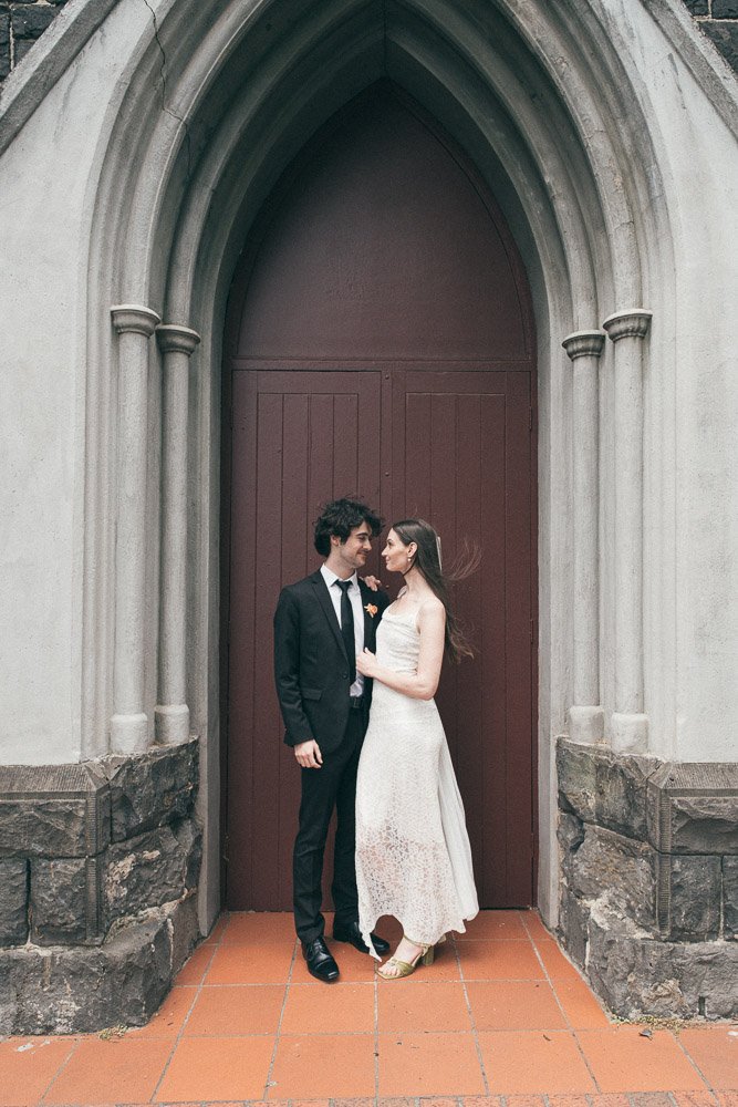 MELBOURNE  EDITORIAL WEDDING PHOTOGRAPHY, BRIDE AND GROOM POSING NEXT TO A CHRUCH DOOR