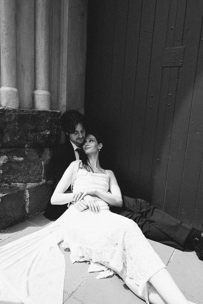 MELBOURNE  EDITORIAL WEDDING PHOTOGRAPHY, BRIDE AND GROOM POSING NEXT TO A CHRUCH DOOR, SITTING ON THE FLOOR