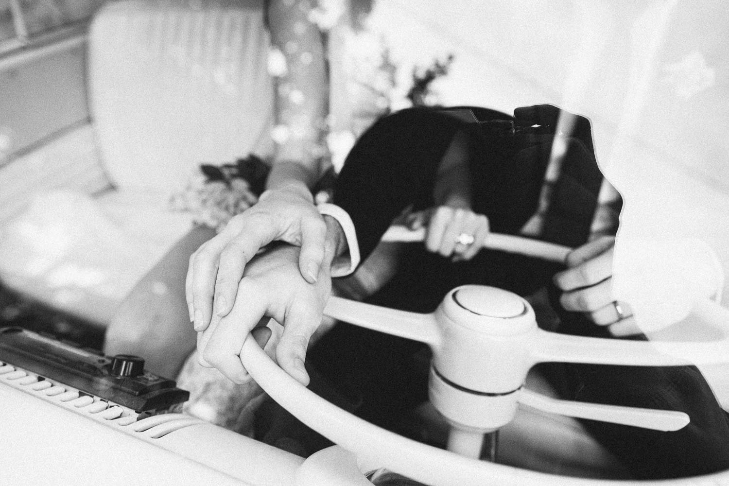 MELBOURNE  EDITORIAL WEDDING PHOTOGRAPHY, BRIDE AND GROOM POSING IN A OLD SCHOOL VW KOMBI VAN, CLOSE UP HOLDING THE CAR WHEEL