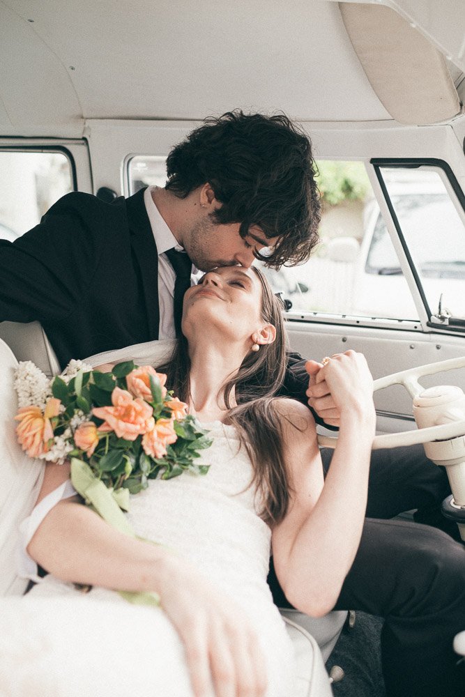 MELBOURNE  EDITORIAL WEDDING PHOTOGRAPHY, BRIDE AND GROOM POSING IN A OLD SCHOOL VW KOMBI VAN, KISSING