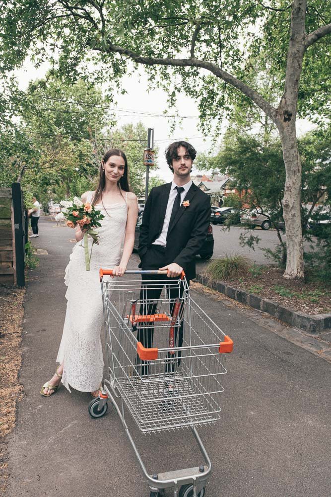 MELBOURNE  EDITORIAL WEDDING PHOTOGRAPHY, BRIDE AND GROOM POSING WITH A COLES SHOPPING TROLLY RANDOMLY FOUND ON THE STREET