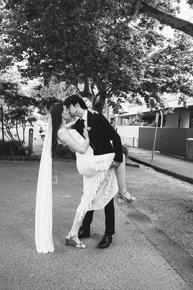 MELBOURNE  EDITORIAL WEDDING PHOTOGRAPHY, BRIDE AND GROOM POSING IN A OLD SCHOOL VW KOMBI VAN, DOING A LEANING KISS