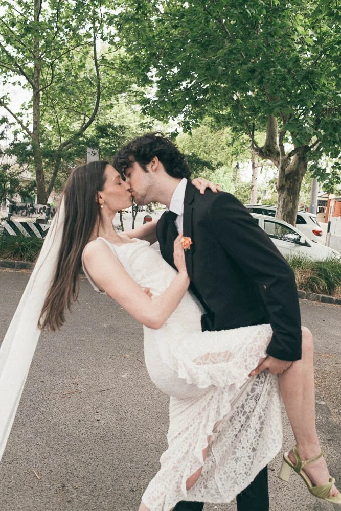 MELBOURNE  EDITORIAL WEDDING PHOTOGRAPHY, BRIDE AND GROOM POSING IN A OLD SCHOOL VW KOMBI VAN, DOING A LEANING KISS