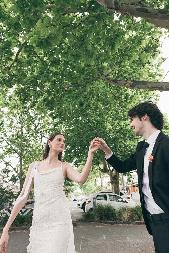 MELBOURNE  EDITORIAL WEDDING PHOTOGRAPHY, BRIDE AND GROOM POSING IN A OLD SCHOOL VW KOMBI VAN, DOING A TWIRL