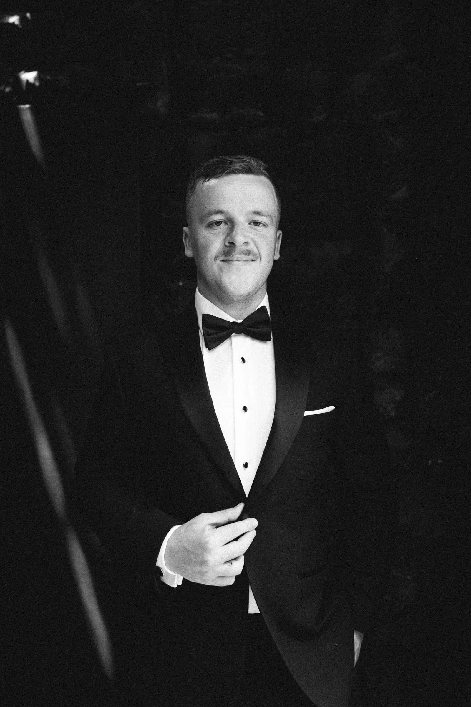 MELBOURNE BOTANICAL GARDEN WEDDING, GROOM GETTING READY, GROOMS PORTRAIT IN A BLACK SUIT