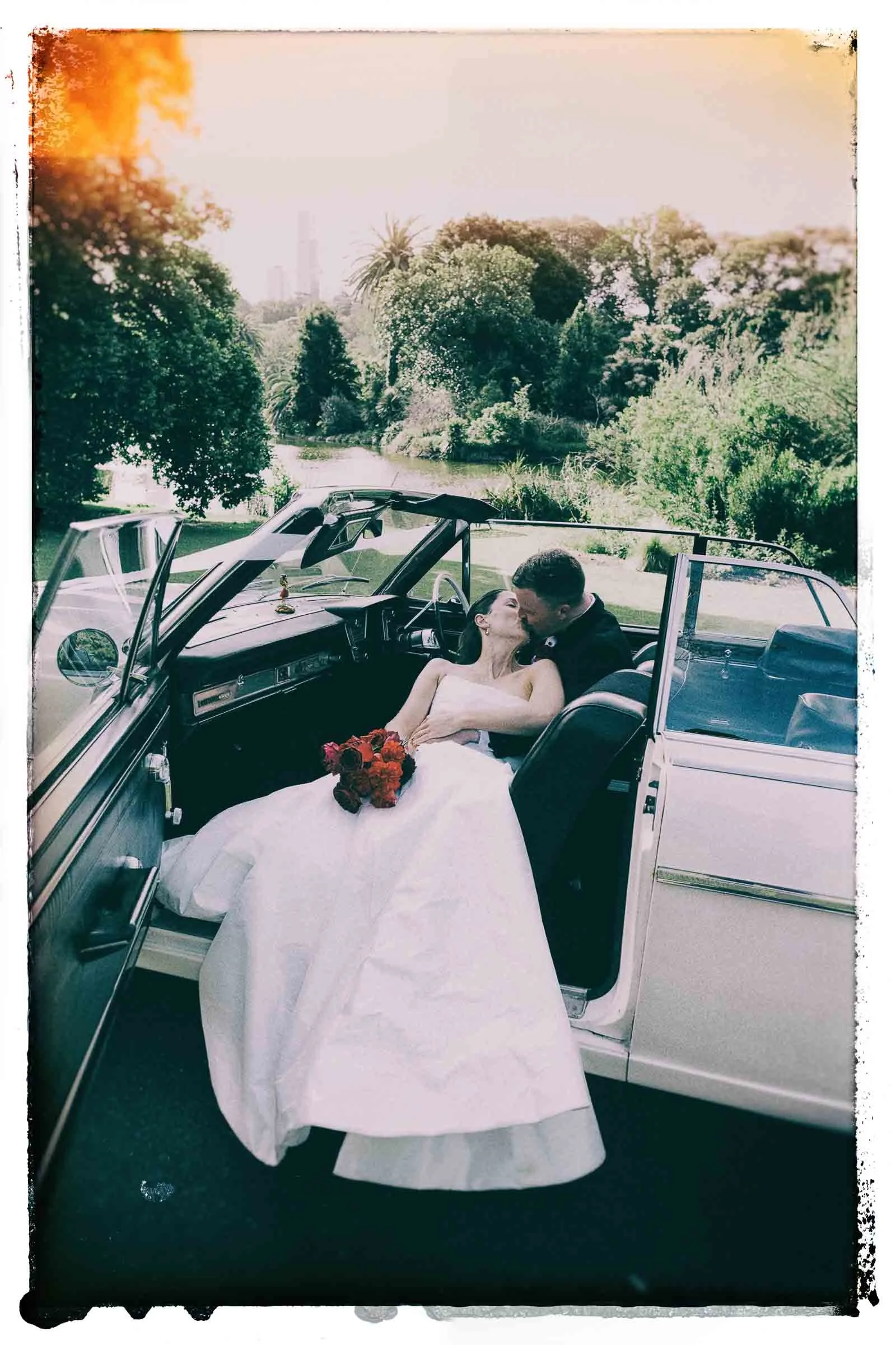 MELBOURNE BOTANICAL GARDEN WEDDING, BRIDE AND GROOM POSING IN A VINTAGE CONVERTIBLE CAR
