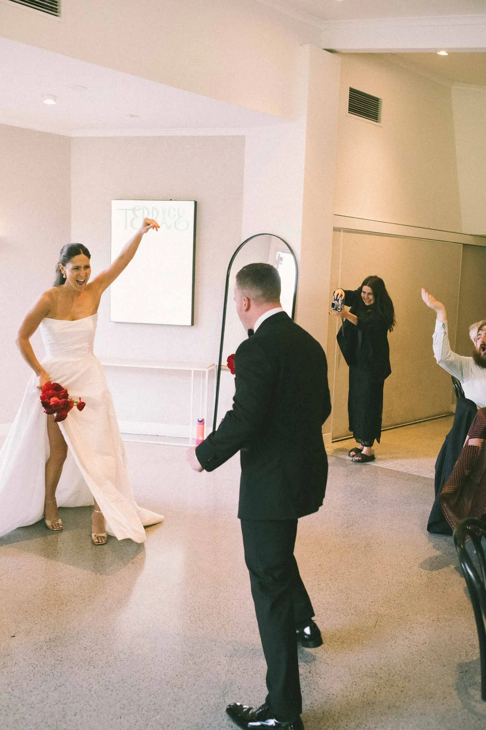 MELBOURNE BOTANICAL GARDEN WEDDING RECEPTION AT THE TERRACE, BRIDE AND GROOMS ENERGY FILLED ENTRY IN THE RECEPTION WITH GUESTS CHEERING