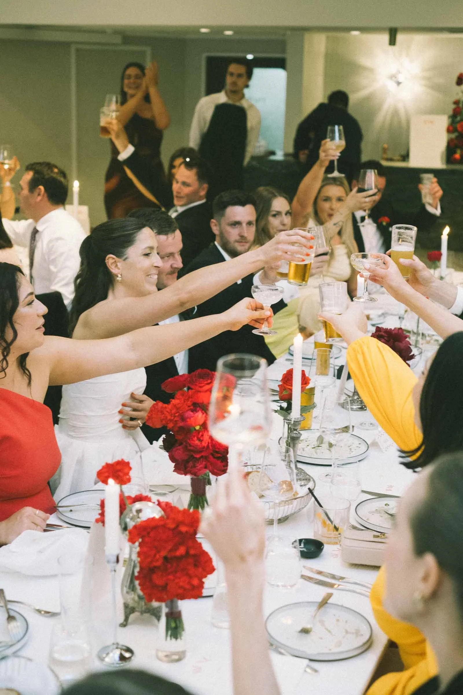 MELBOURNE BOTANICAL GARDEN WEDDING RECEPTION AT THE TERRACE, BRIDE AND GROOMS ENERGY FILLED ENTRY IN THE RECEPTION WITH GUESTS CHEERING, RAISING A TOAST WITH THE GUESTS