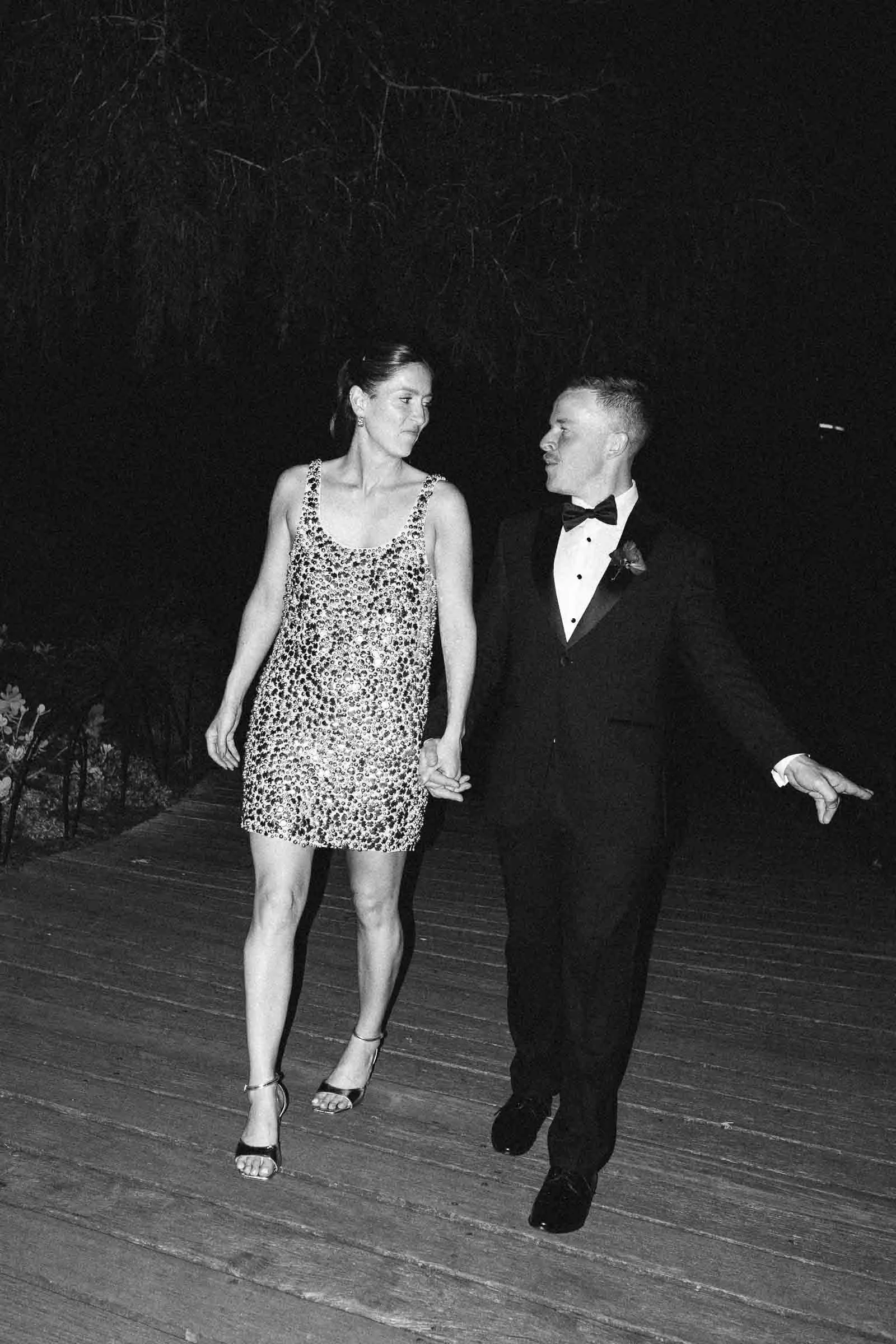 BRIDE AND GROOM FLASH PHOTO IN THE DARK TAKING A WALK TOGETHER