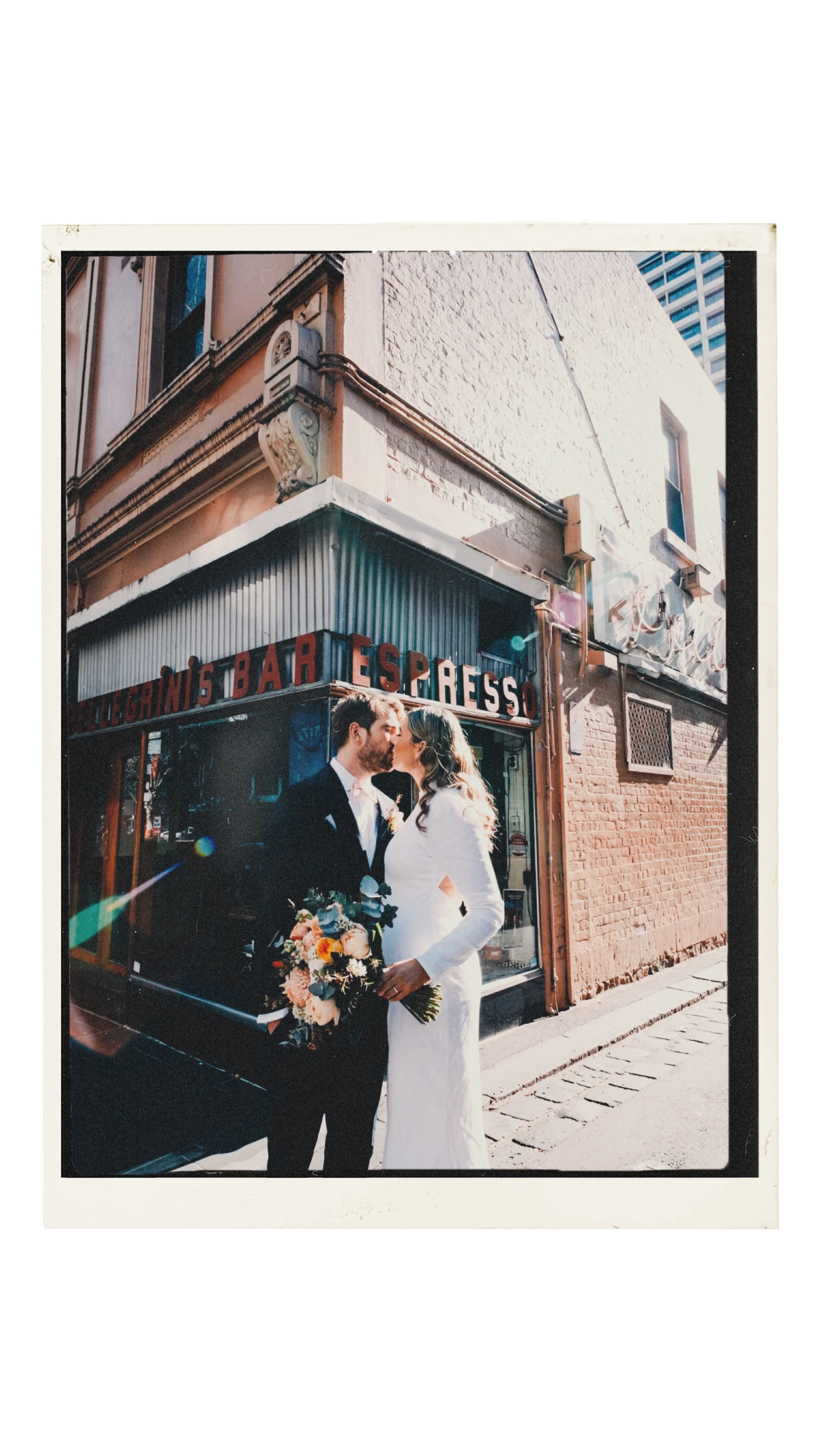 IMAGE OF A COUPLE KISSING IN FRONT OF PELEGRINIS BAR IN THE HEART OF MELBOURNE CBD