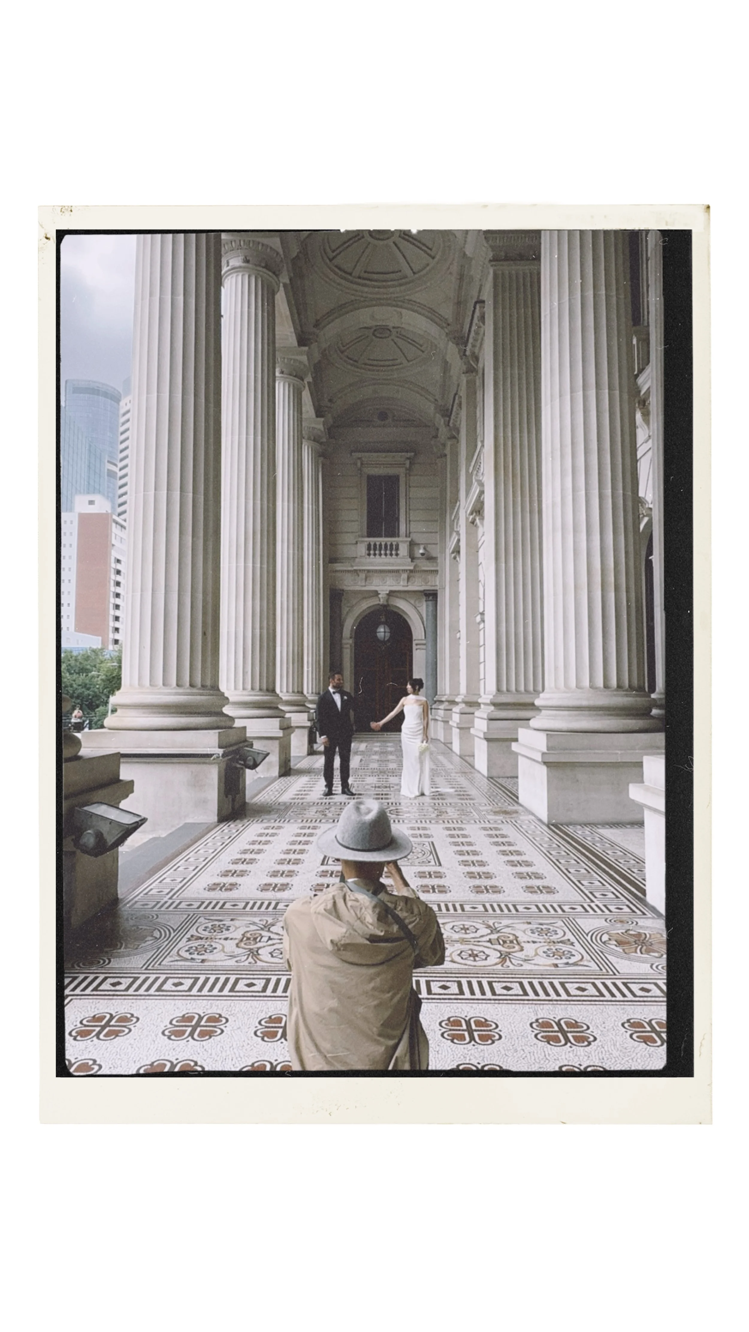 IMAGE OF AN ELOPEMENT COUPLE HOLDING HANDS WHILE RJ THE PHOTOGRAPHER IS IN THE FOREGROUND OF THE FRAME
