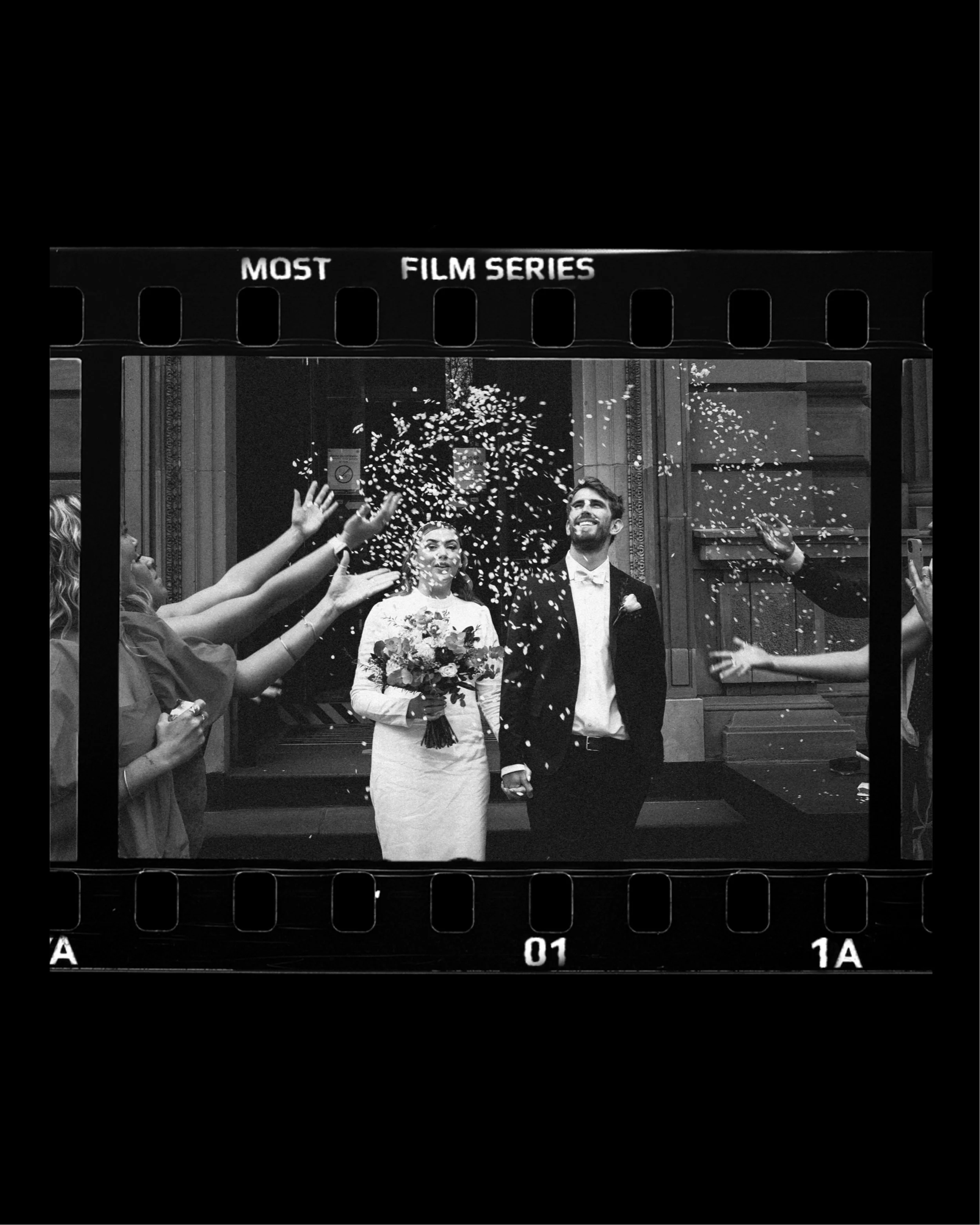 A wedding couple showered with confetti outside the treasury building after their elopement wedding