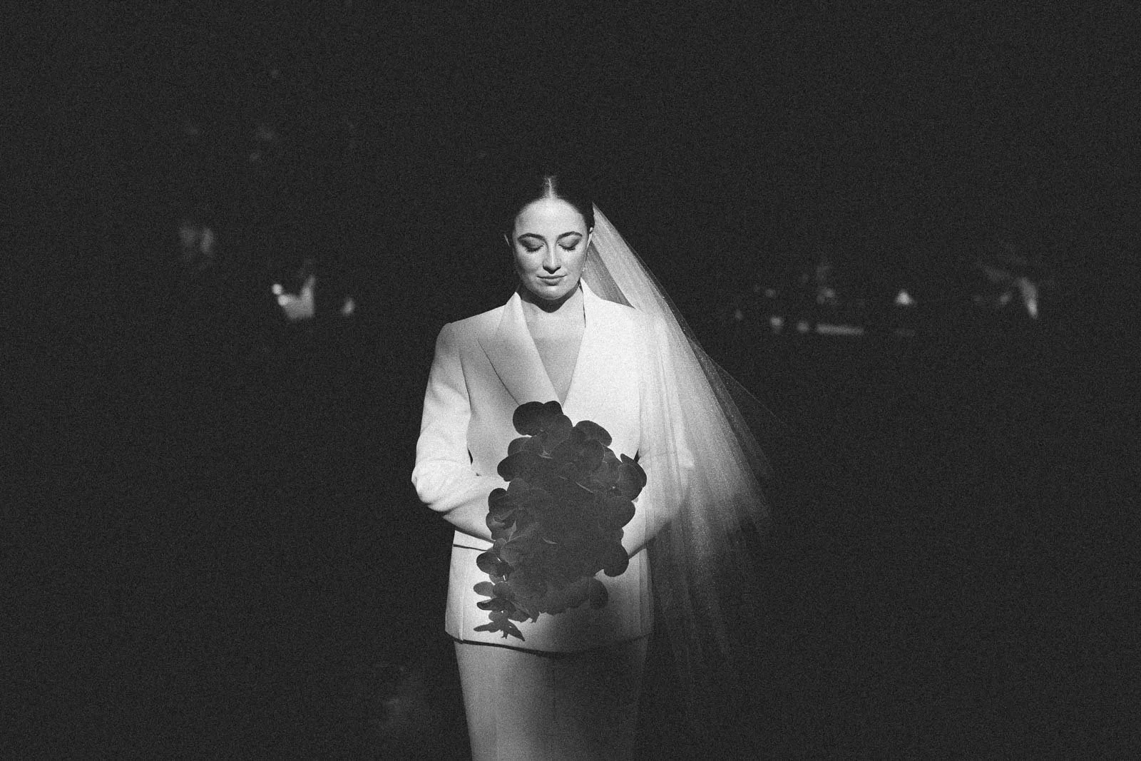 MELBOURNE ELOPEMENT PHOTOGRAPHY GUIDE, A BRIDE HOLDING FLOWERS INTIMATE LIT AT THE TREASURY GARDENS