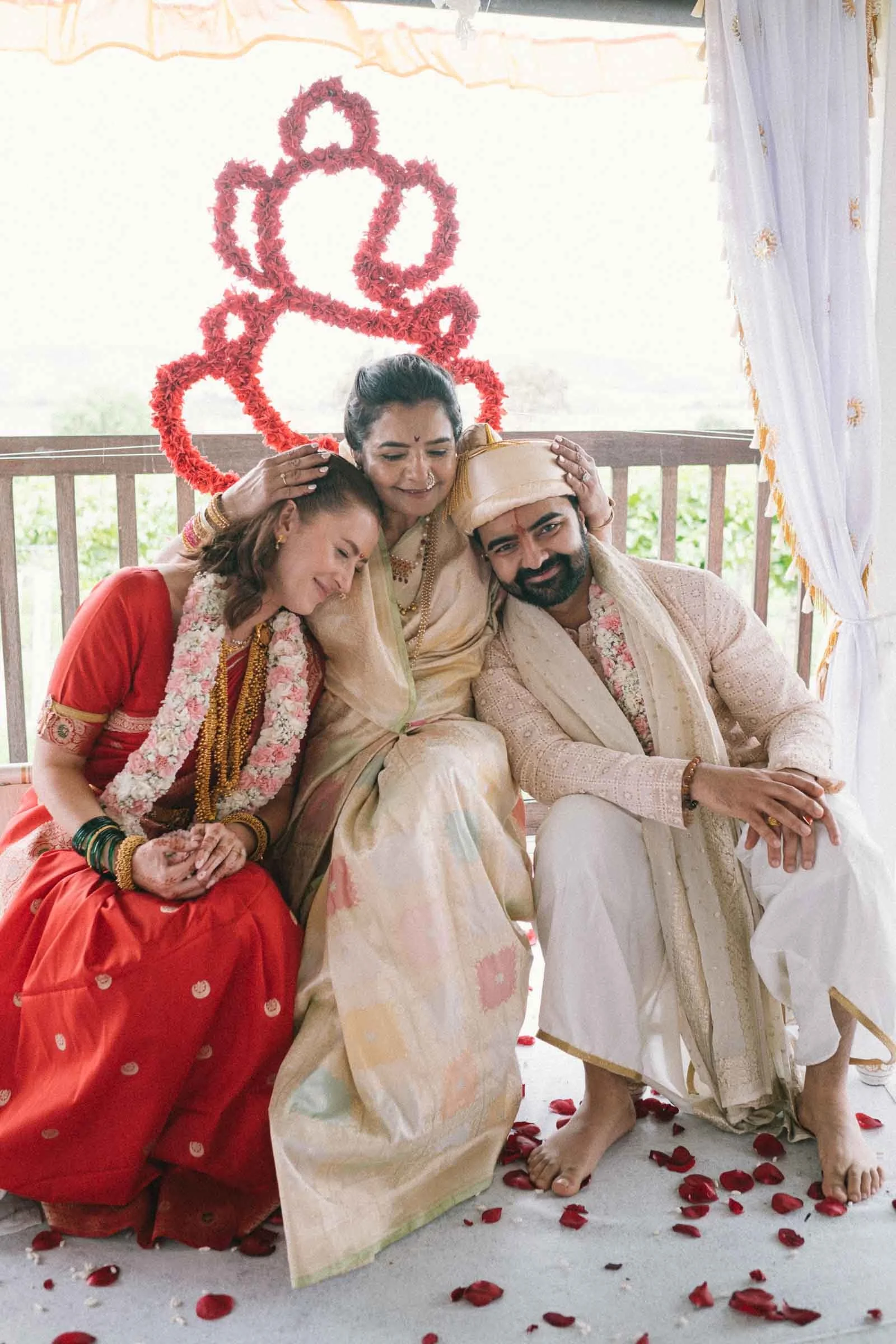 Mother of the groom hugging the Indian groom and Australian bride after the wedding ceremony