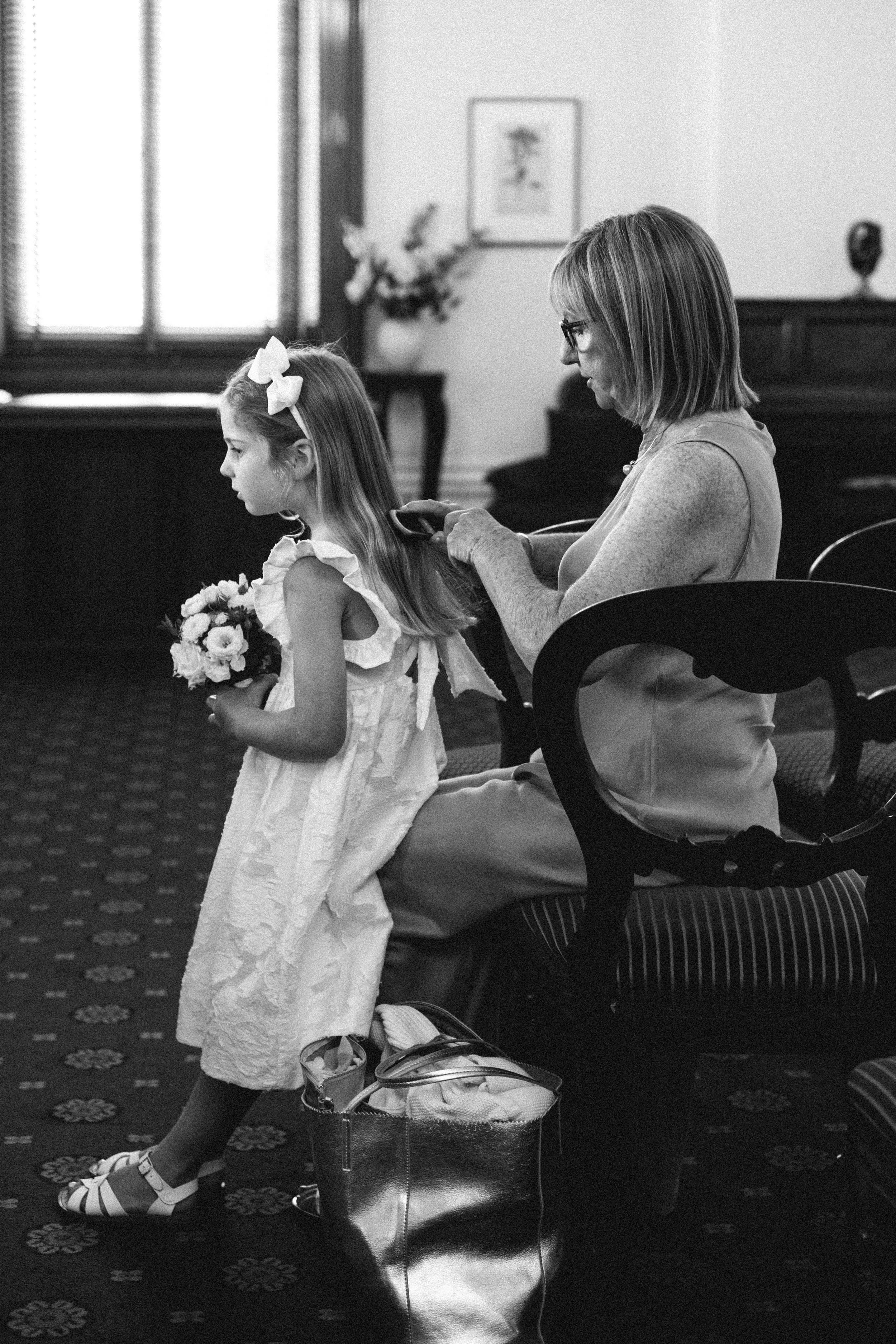 A CANDID WEDDING PHOTOGRAPHY MOMENT, FLOWER GIRL GETTING READY