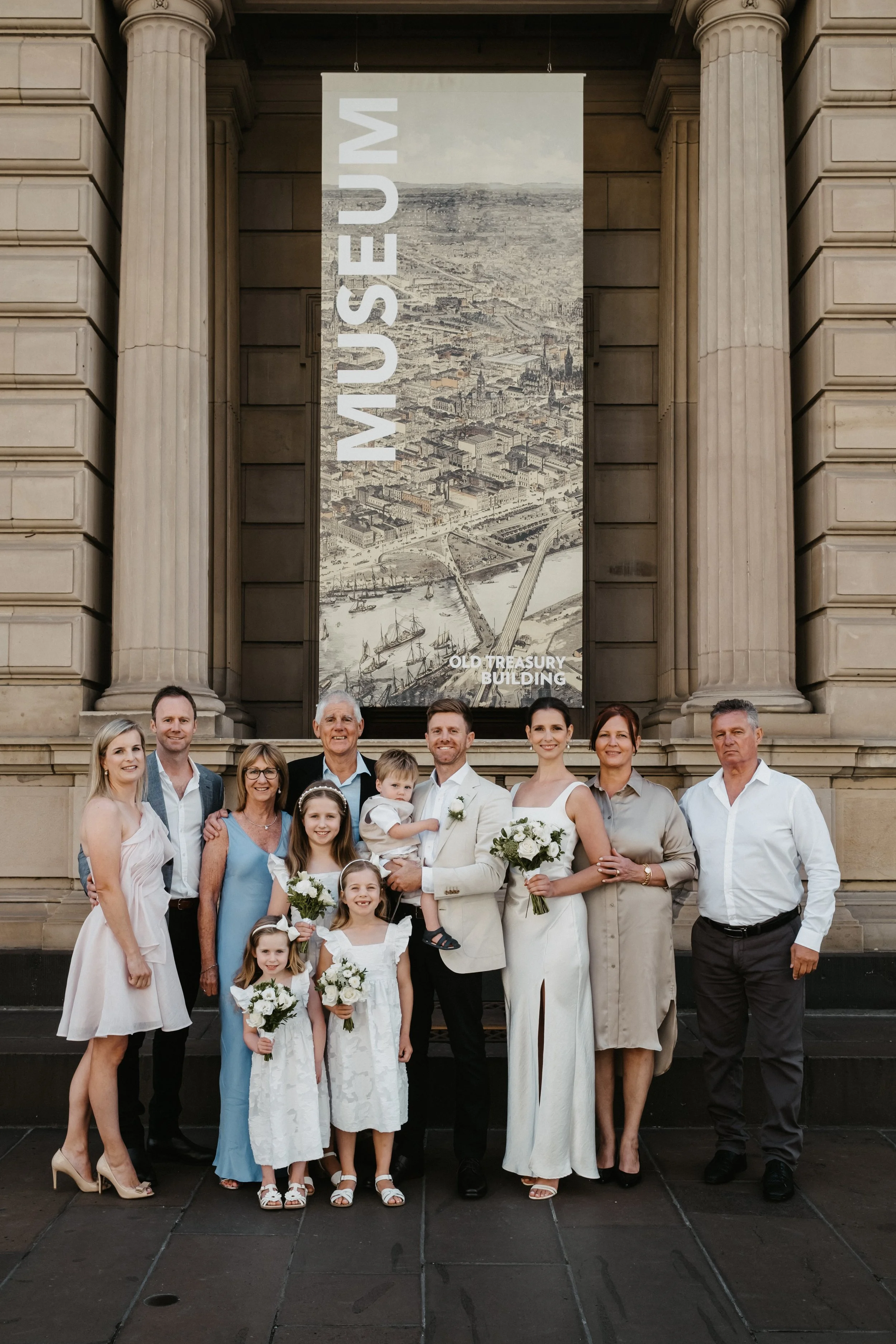 FAMILY PORTRAIT OUTSIDE OLD TREASURY BUILDING OF A WEDDING COUPLE