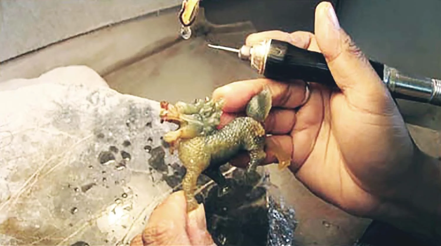 Jade is extremely hard and near impossible to carve. Instead,  you must abrade it. This involves wearing away the stone with an abrasive substance — normally sand and water — or various drilling tools
