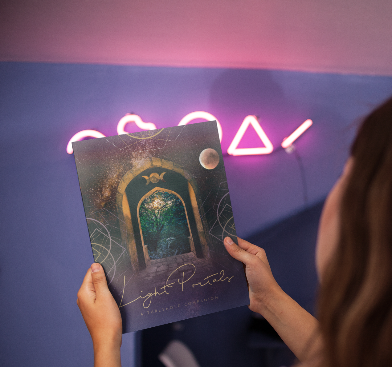 over-shoulder-mockup-of-a-girl-holding-a-magazine-in-a-room-with-pink-neon-lights-a14403.png