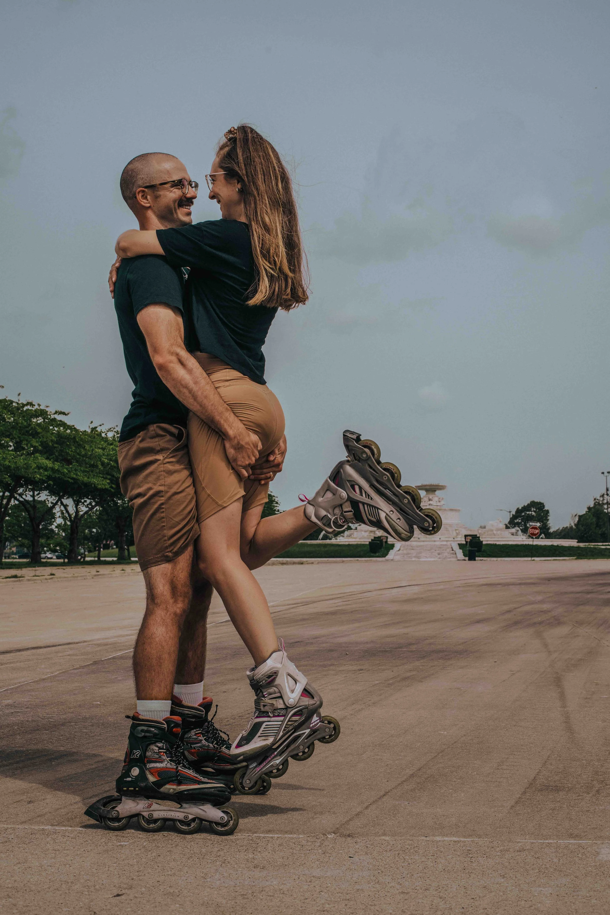 Authentic moment of an engaged couple rollerblading together, captured in a lifestyle engagement session by Forever Ago Photography at Belle Isle Detroit Michigan