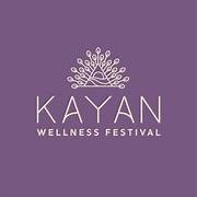 Purple background with white logo and text for Kayan Wellness Festival, featuring a stylized tree or plant design above the festival name.
