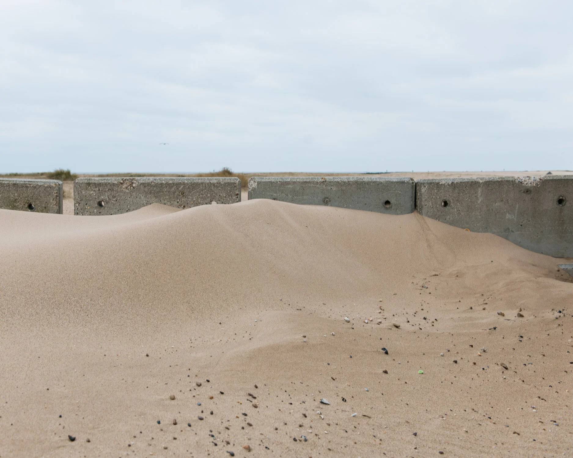 The prevailing wind sweeps the sand North, piling it up on the defences, Jaywick.