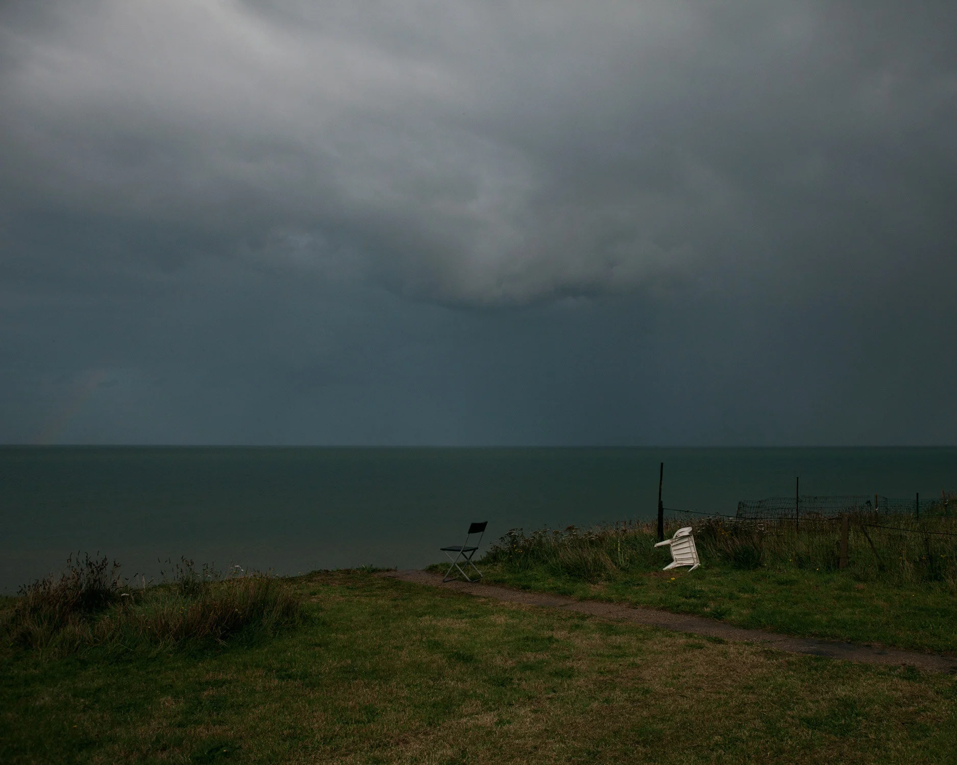 A storm brews in Bryony's back garden, half of which has been lost to the sea.