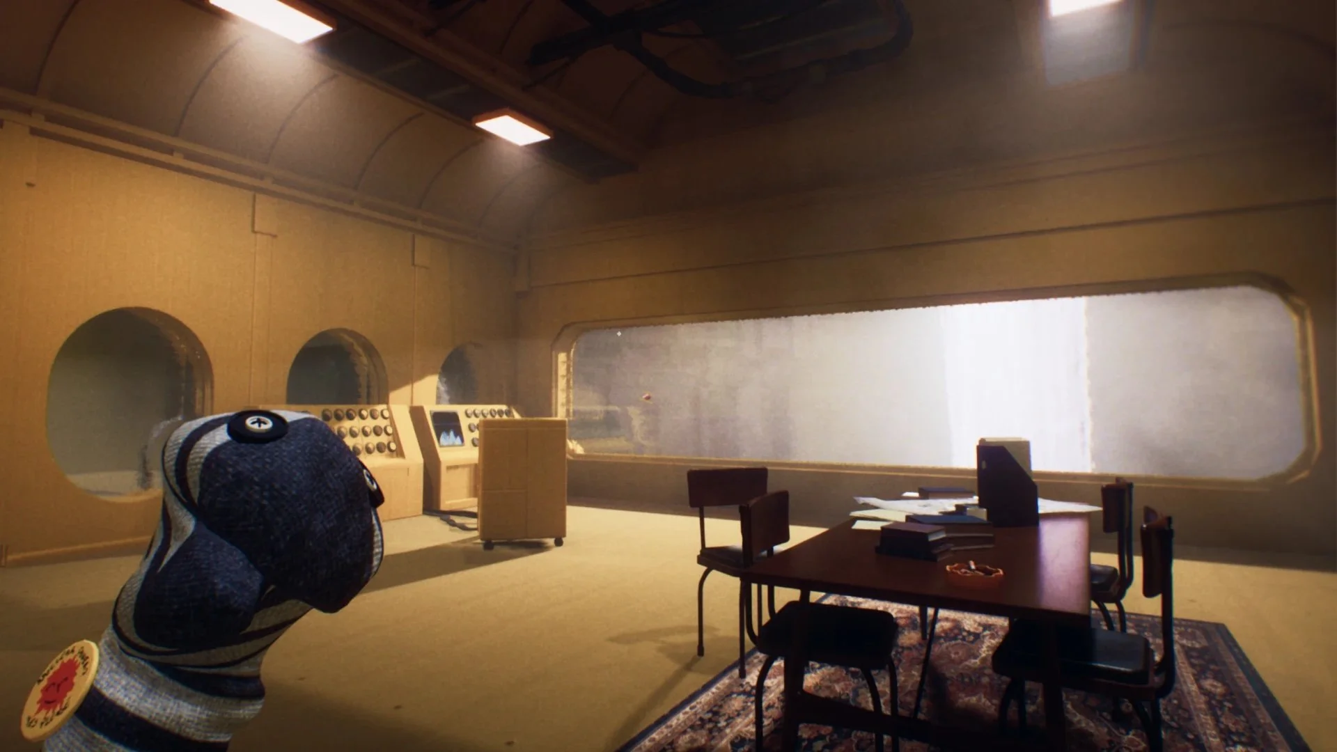 Transit game screenshot: the sock puppet guide in a sunlit cardboard control room with a desk and chairs