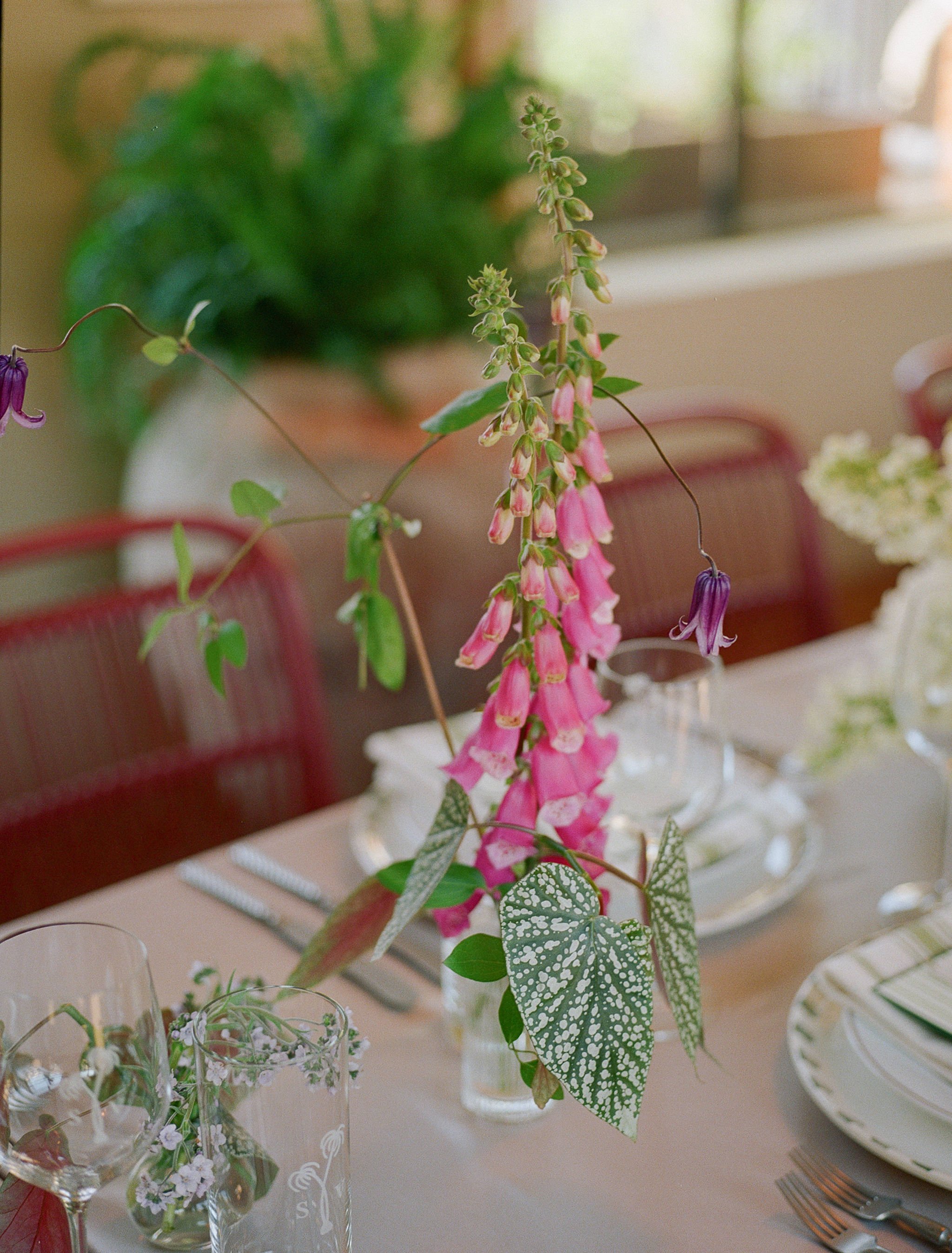 Floral centerpiece featuring pink foxglove and seasonal blooms